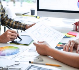 Team of young Interior graphic designer working sketching on gra Team of young Interior graphic designer working sketching on graphic tablet and color swatch, discussing of house project at modern office, creative work place inspiration and imagine.